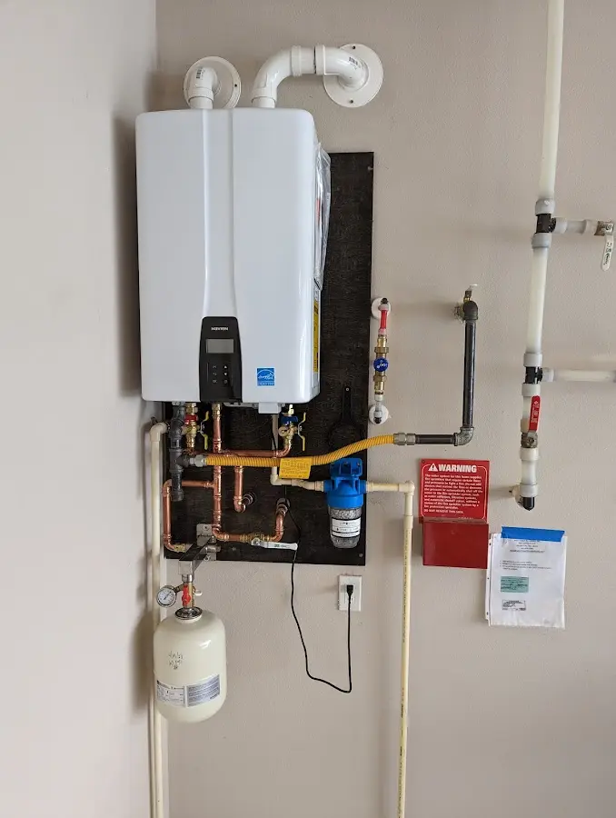 Professional plumber installing copper piping in a Charlottesville home